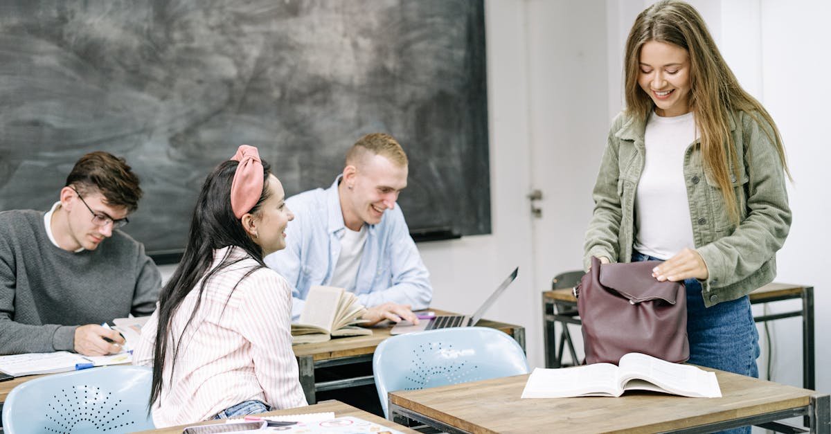 A group of students studying and interacting in a bright classroom setting.