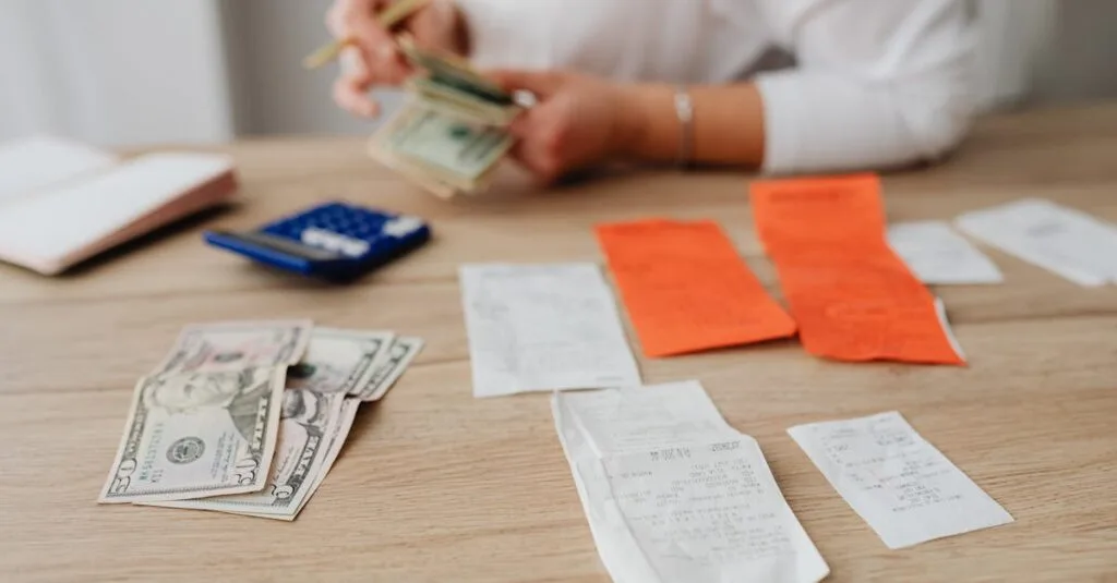 A person using a calculator and cash to plan a household budget.