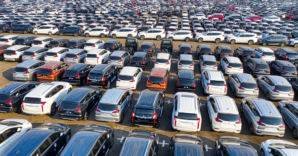 From above of rows with many modern new shiny automobiles of contemporary industry in daytime
