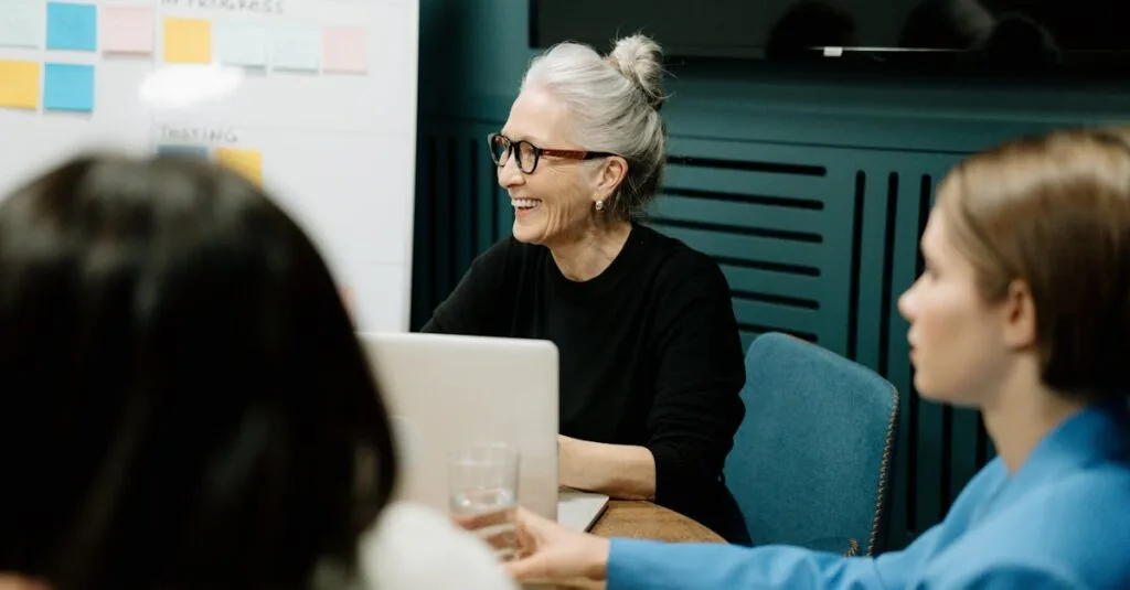 Smiling senior businesswoman leading a diverse team meeting in an office.