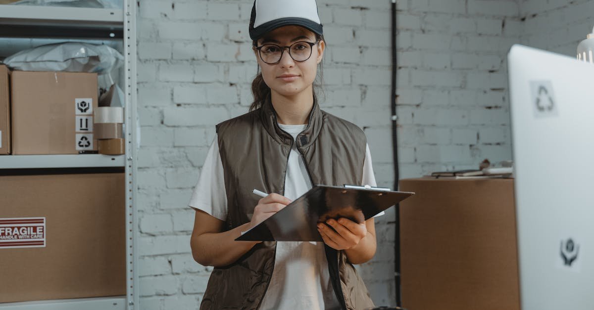 Young woman with clipboard in a warehouse, managing inventory with precision.
