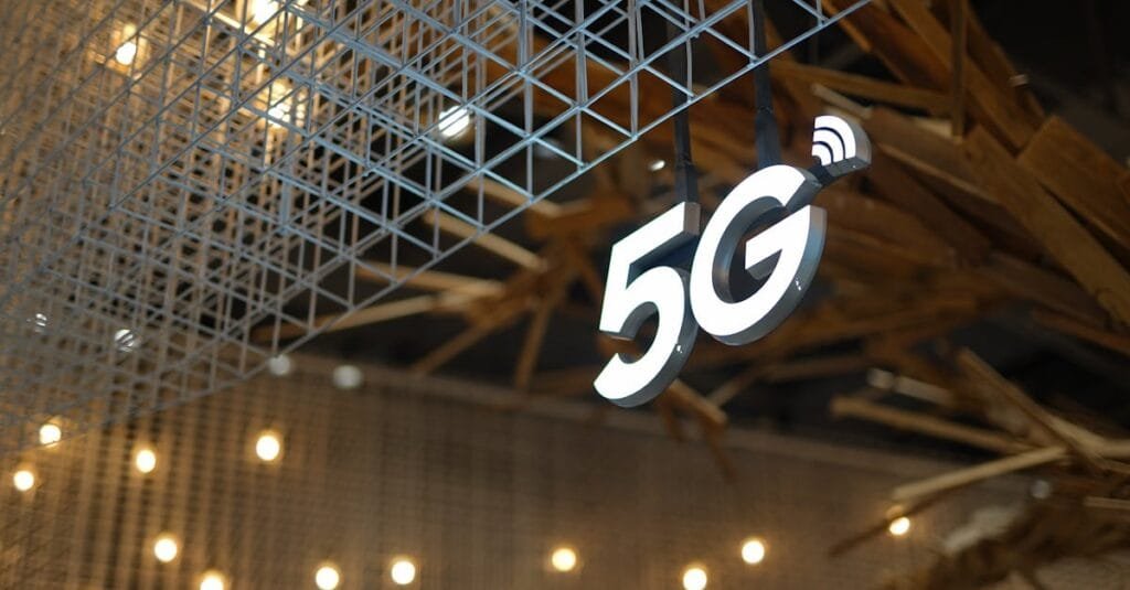Illuminated 5G sign with modern geometric ceiling and warm lighting.