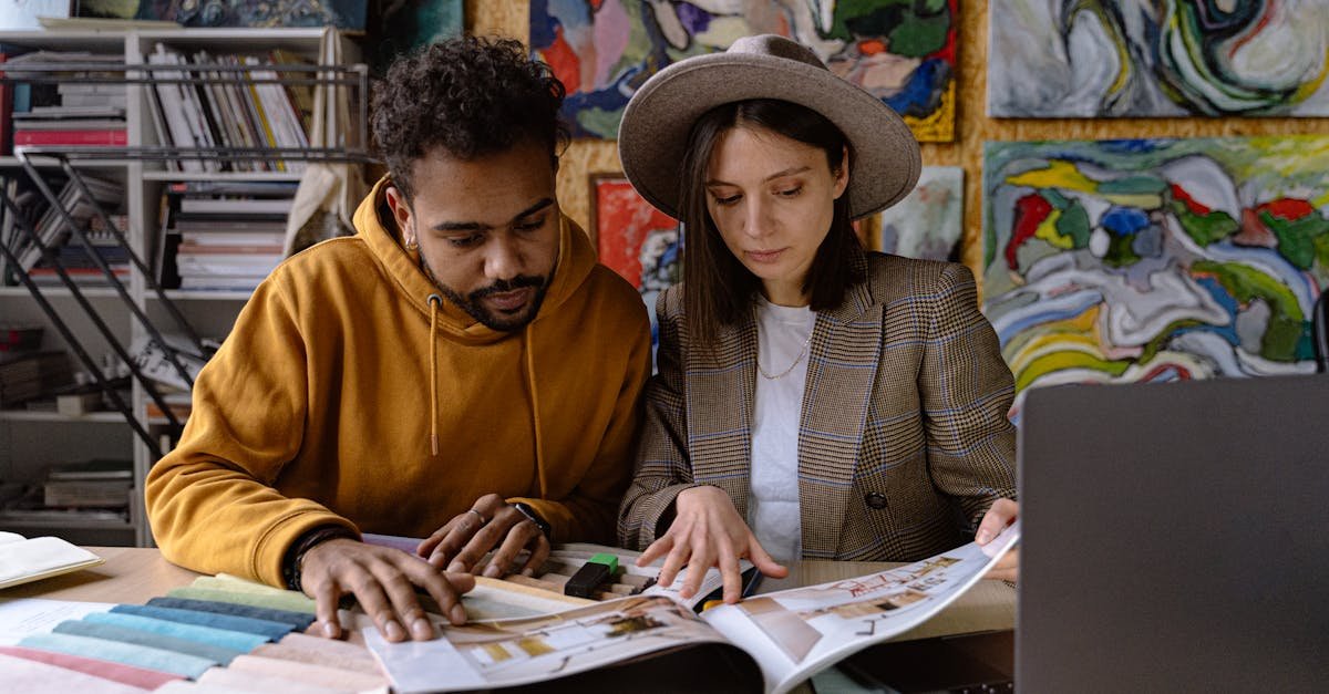 Two designers analyzing design projects together in a vibrant creative space.