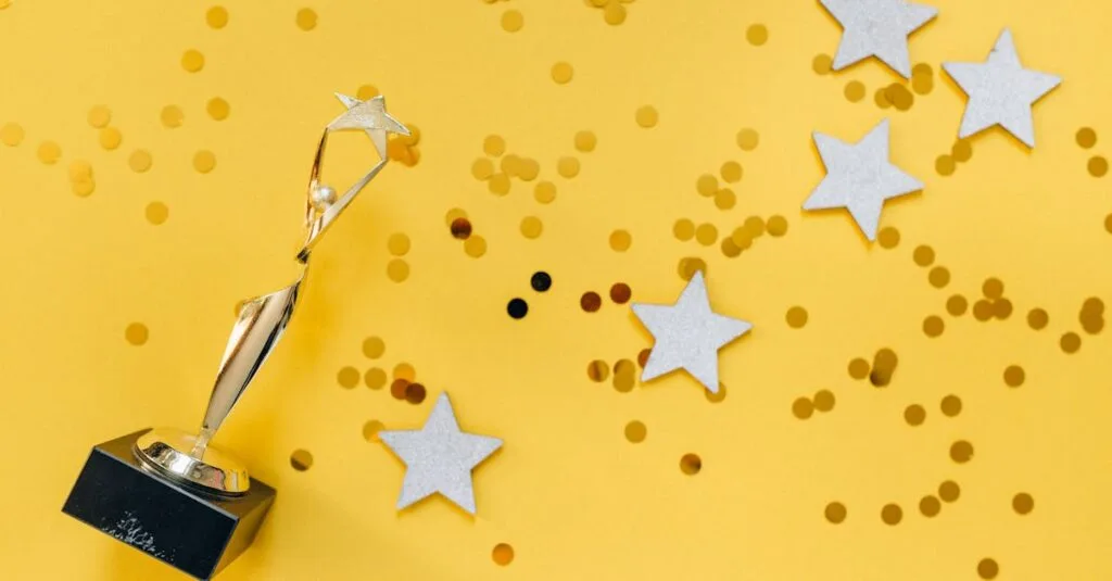Shiny golden trophy and stars on a vibrant yellow background, symbolizing success and victory.