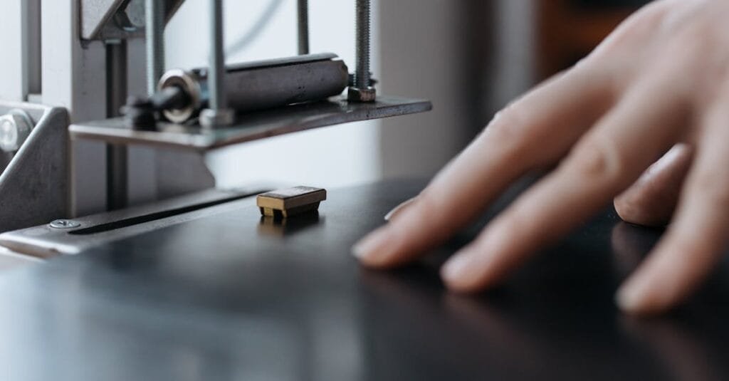 A hand operating an industrial machine, focusing on the delicate touch and intricate machinery.