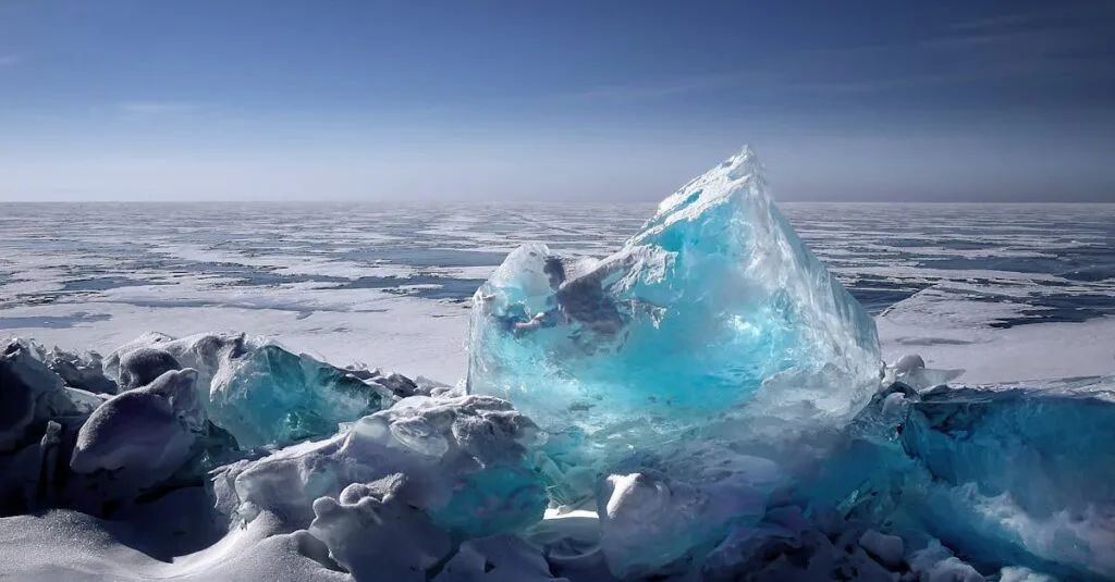 Captivating ice formation on a frozen lake under a bright blue sky during winter.