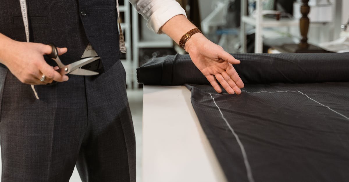Close-up of a tailor cutting fabric with scissors in a fashion studio, highlighting bespoke craftsmanship.
