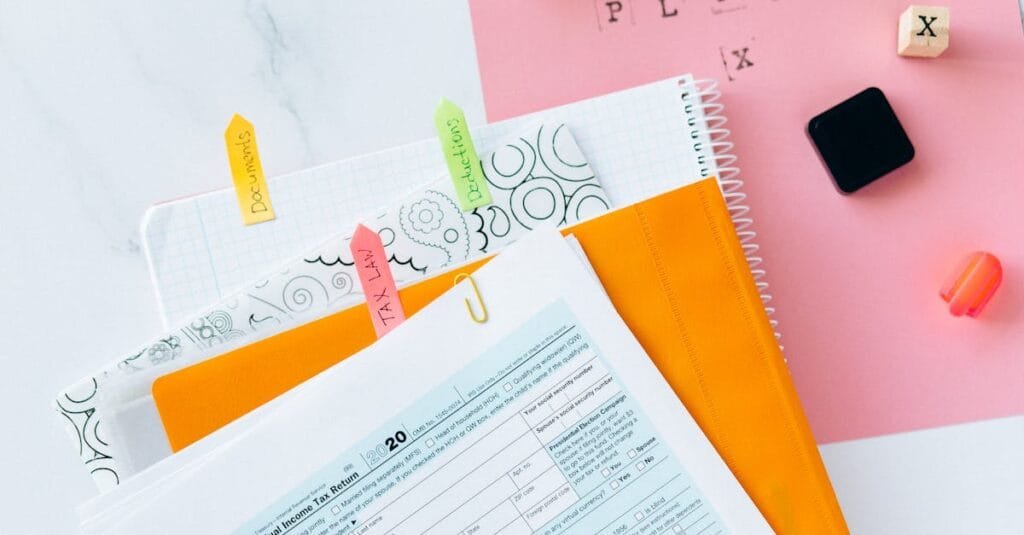 Overhead view of tax documents, forms, and organized work area for tax preparation.