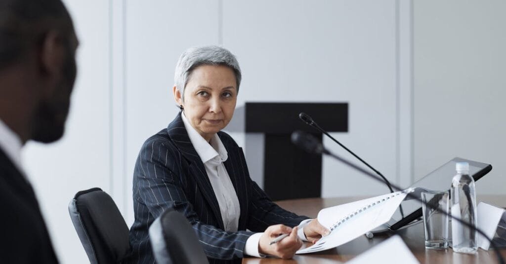 Senior businesswoman leading a conference discussion with a diverse team.