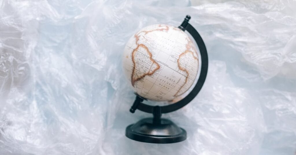 A globe wrapped in plastic symbolizes environmental issues and the need for sustainability.