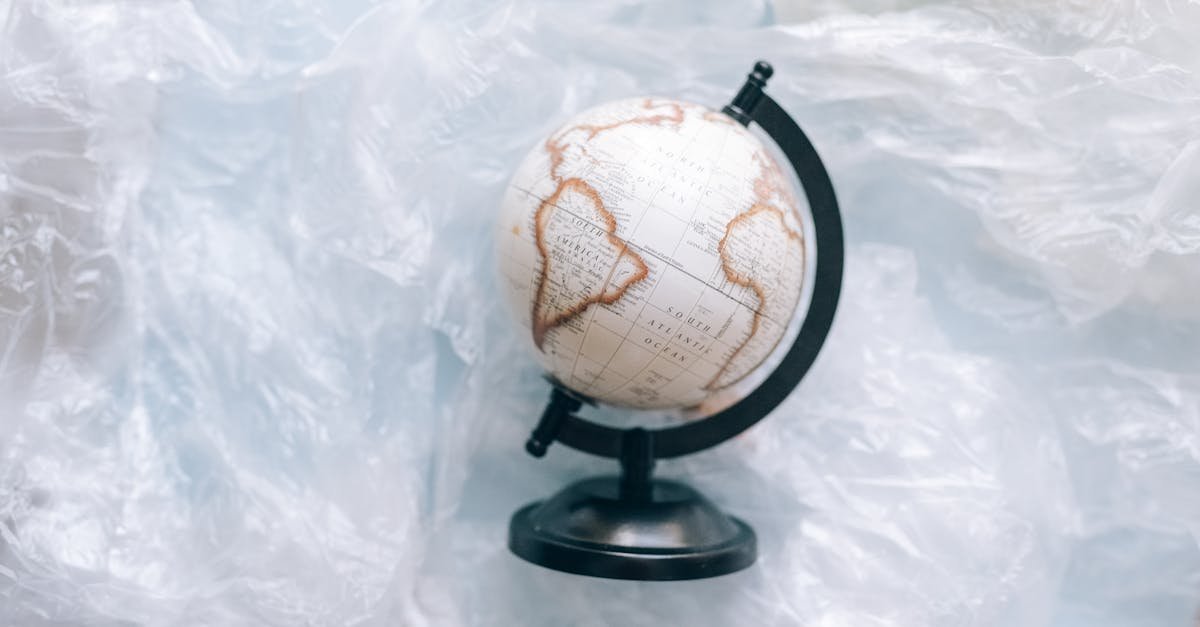 A globe wrapped in plastic symbolizes environmental issues and the need for sustainability.