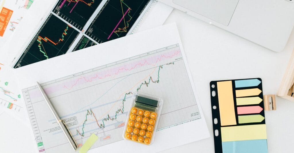 Flat lay of financial charts and tools on office desk, ideal for business and finance concepts.