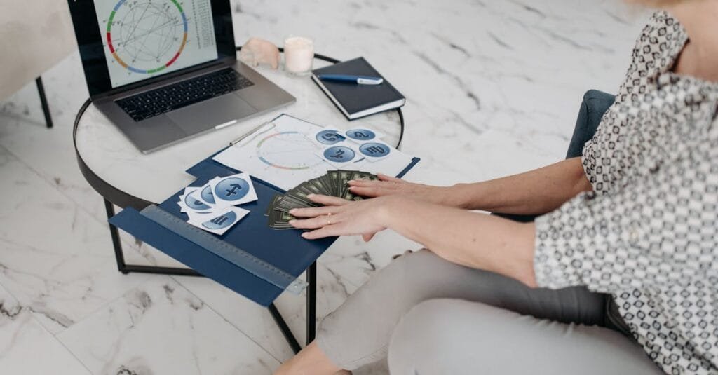 Astrology scene with a woman using a laptop and tarot cards in a modern living room.