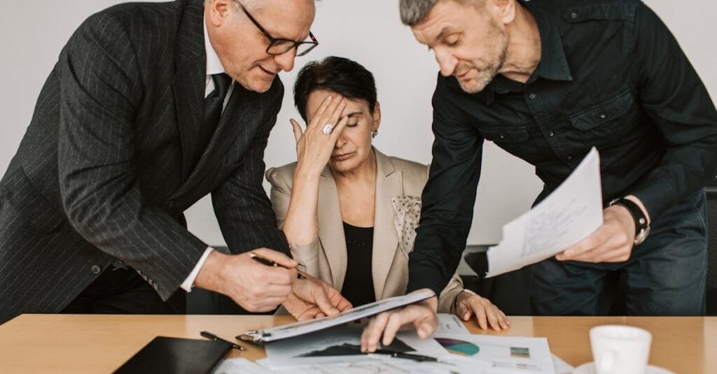 A professional team in a tense business meeting discussing financial documents.