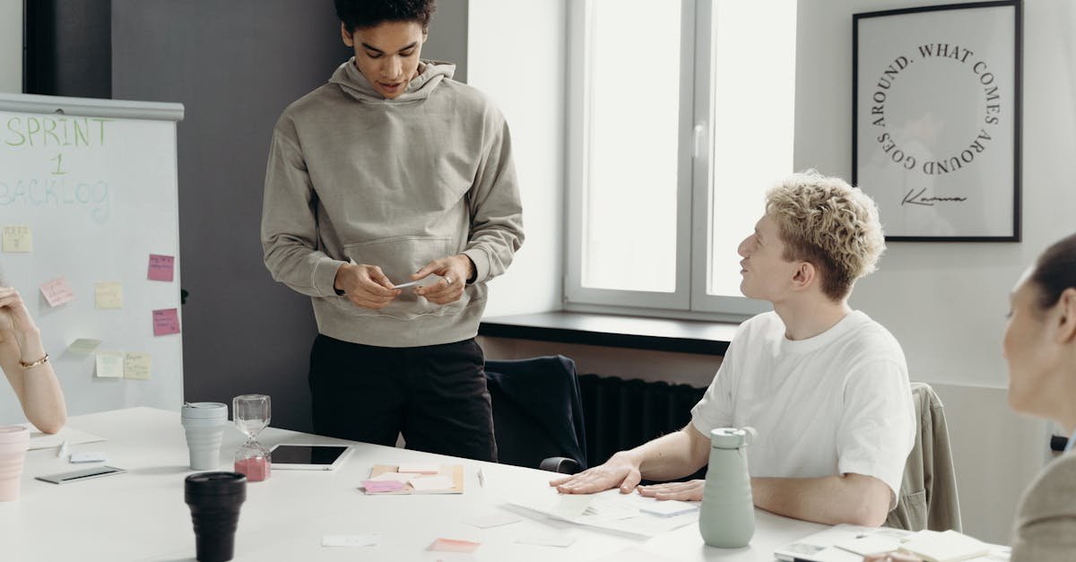 A diverse team discusses project ideas in a modern office setting.