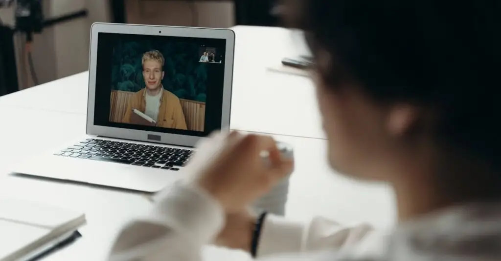 Two professionals having a virtual meeting via laptop in an office setting.