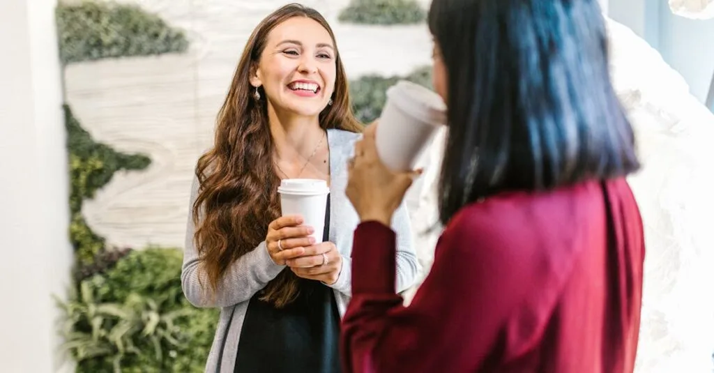 Two women in a modern office setting enjoying a casual coffee break, highlighting teamwork and relaxation.