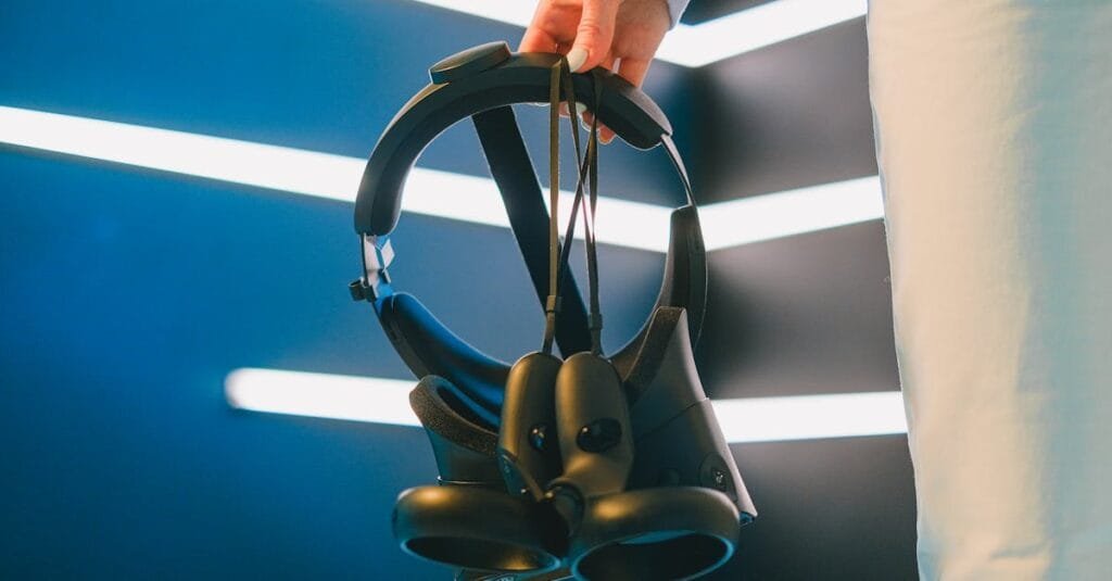 Close-up of a hand holding a VR headset in a modern, high-tech environment.