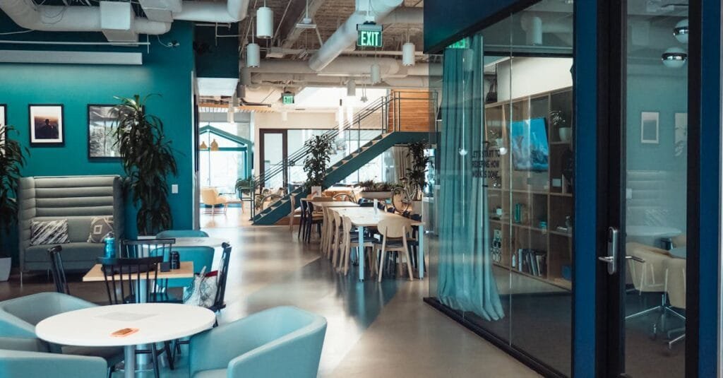 Open and collaborative modern office space with stylish furniture and natural lighting.