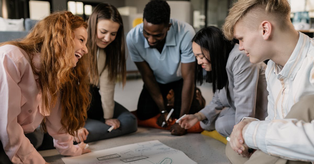 A diverse team of adults collaborating on a project in a modern office setting.