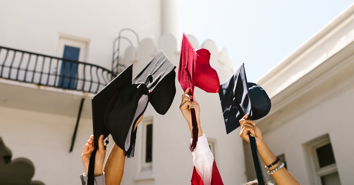 Graduates celebrate by tossing caps into air, marking joyous graduation ceremony.