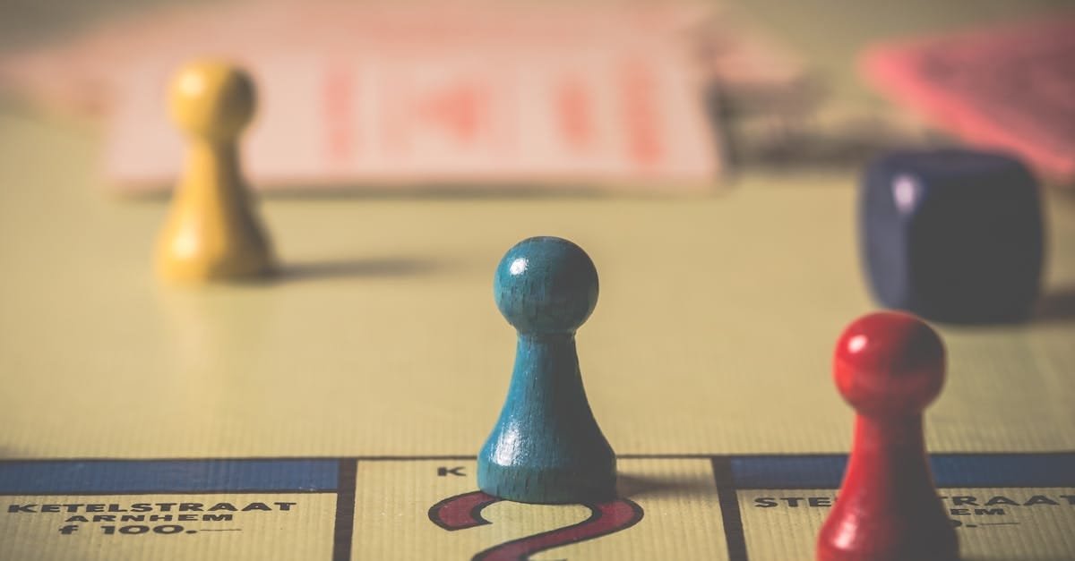 Close-up of a classic board game with vibrant tokens and dice on a playing board.