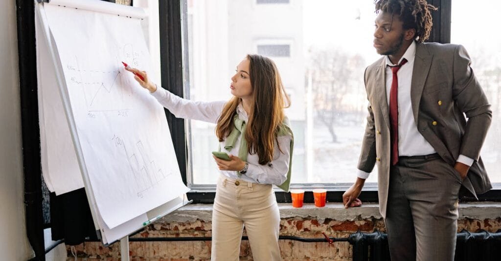 Corporate team discussing business strategies during an office presentation.
