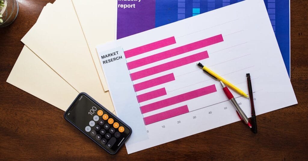 Top view of market research reports and calculator on a wooden desk, illustrating business analysis.