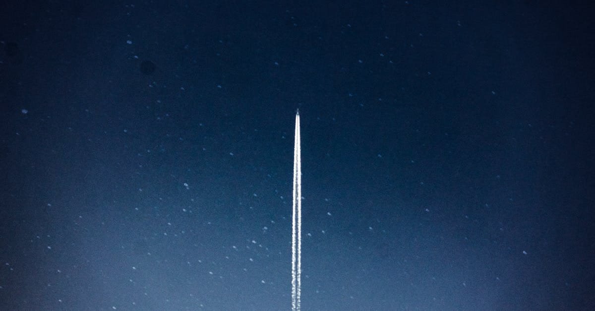 A rocket streaks through a starry night, leaving a trail in outer space.