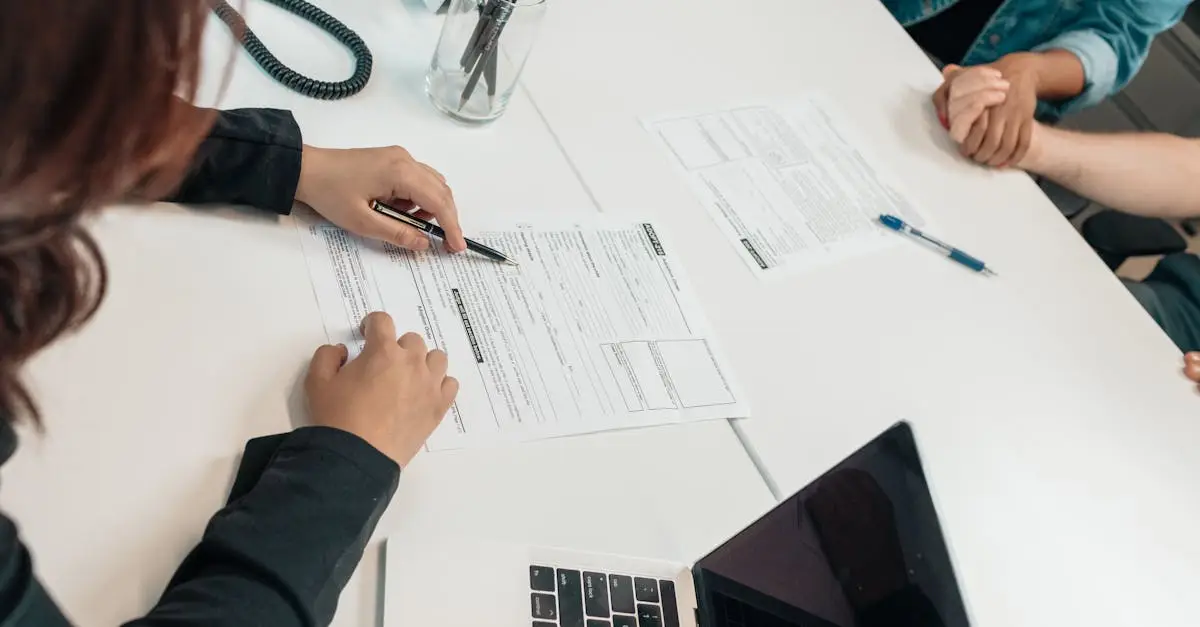 A professional meeting with document signing at an office desk, focusing on teamwork.