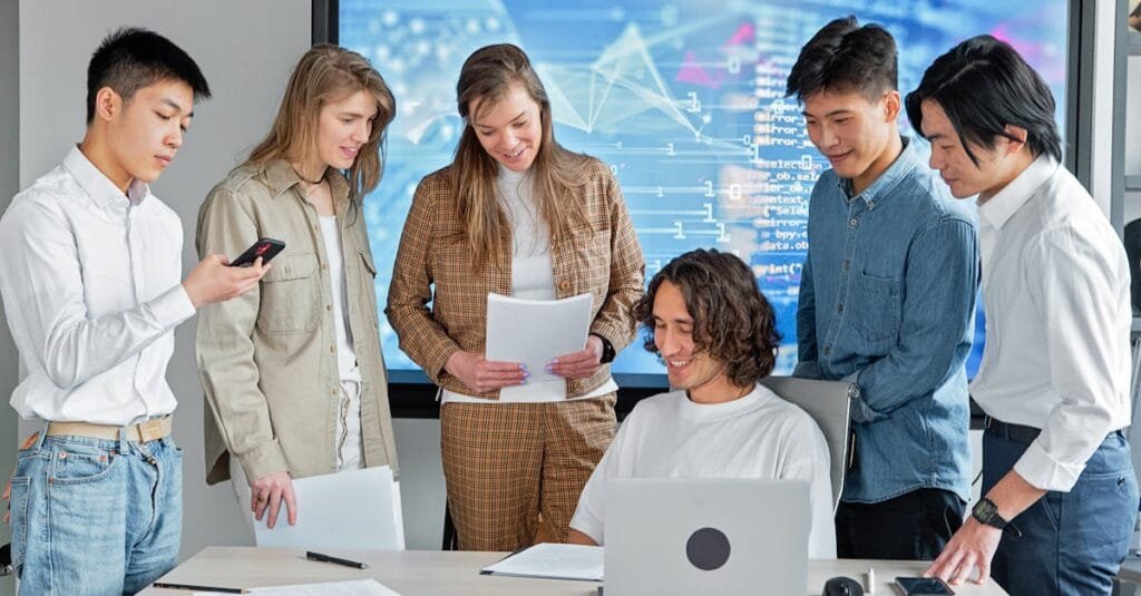 Diverse team collaborating in a modern office with technology.
