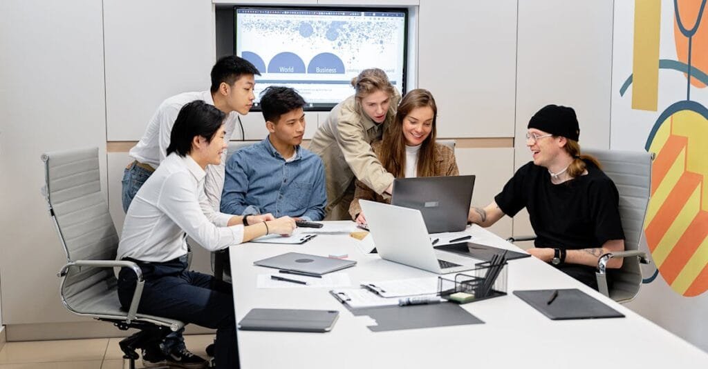 A diverse team of professionals engaged in a collaborative meeting inside a modern office setting.