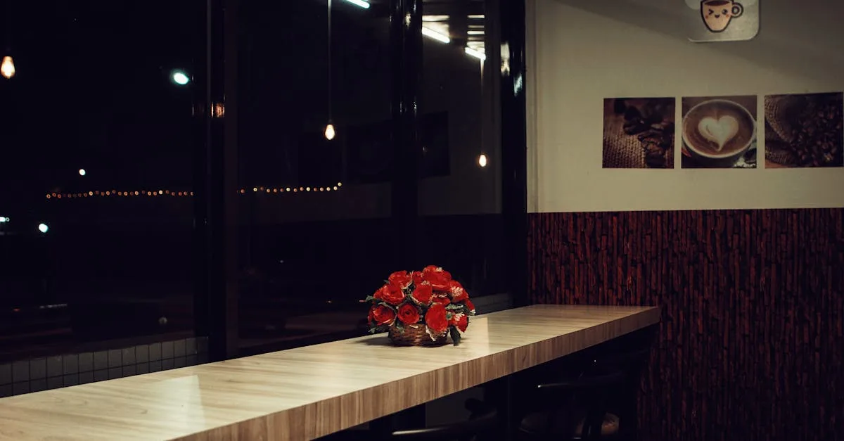 Contemporary coffee shop interior featuring minimalist design with red flowers and ambient lighting.