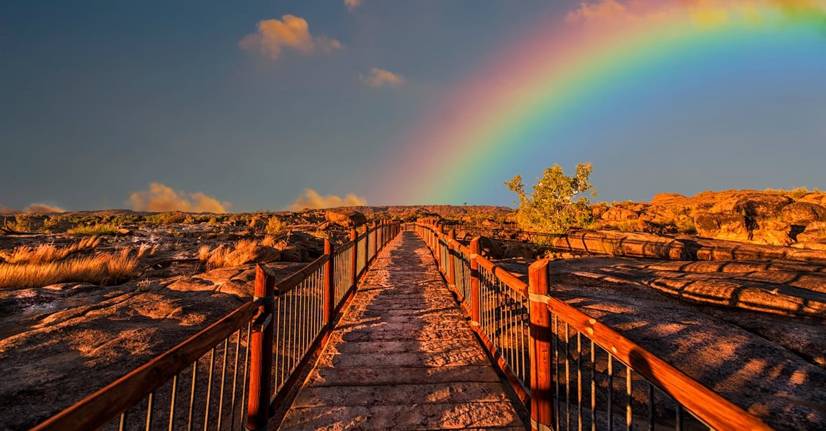 A scenic walkway with a rainbow arching across a vivid sky, perfect for outdoor photography.