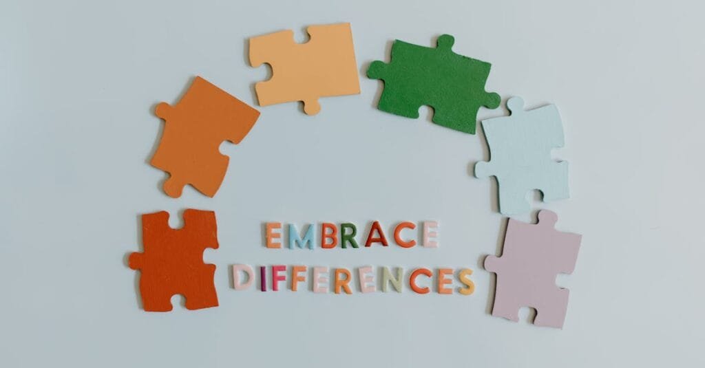 Colorful puzzle pieces and slogan embracing diversity on a white background.