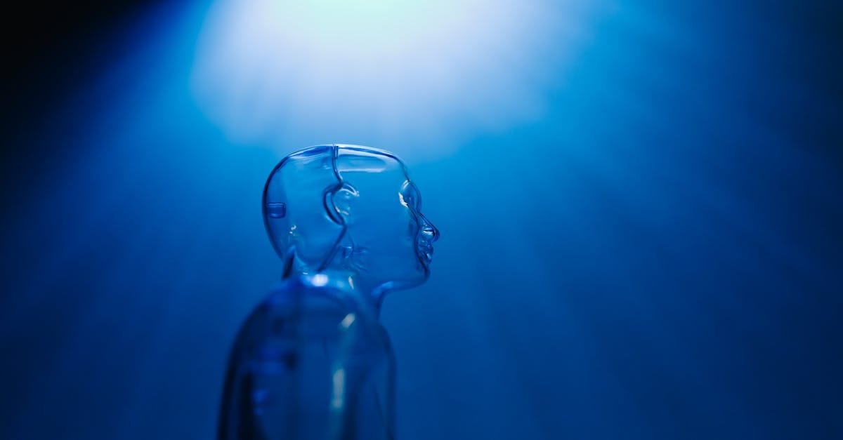 Transparent robotic figure illuminated by blue light, symbolizing AI and futuristic technology.