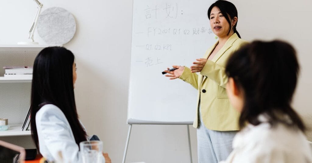Confident businesswoman presenting strategy to colleagues in a modern office setting.