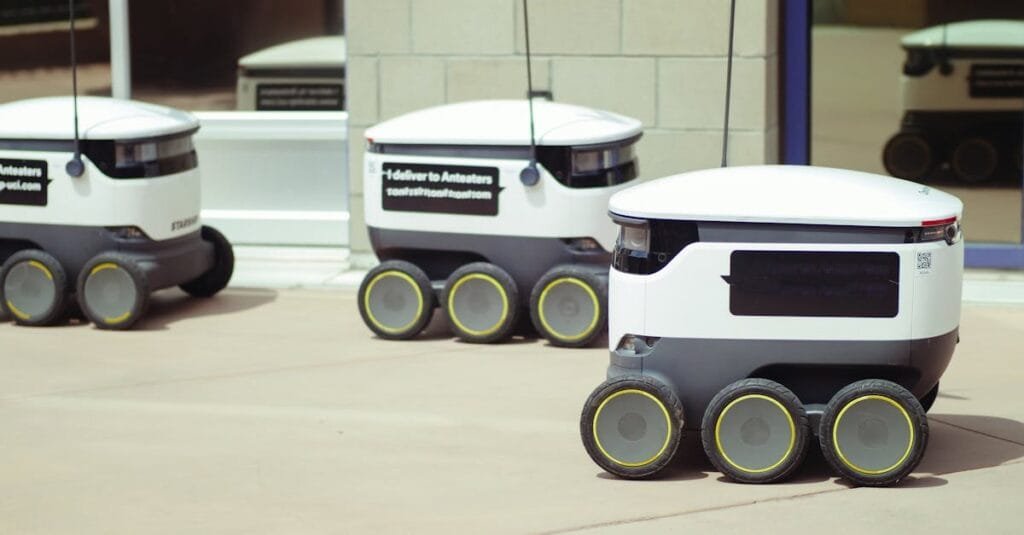 Autonomous delivery robots on a city sidewalk demonstrating modern technology for urban mobility.