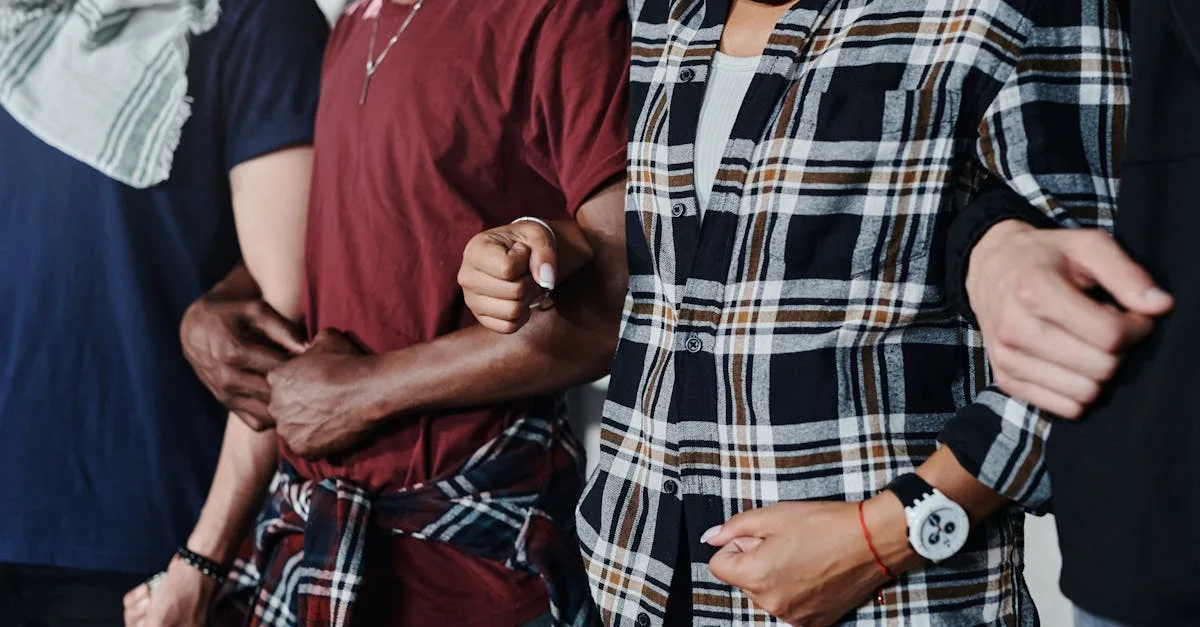 Close-up of a diverse group of adults linking arms, symbolizing unity and solidarity.