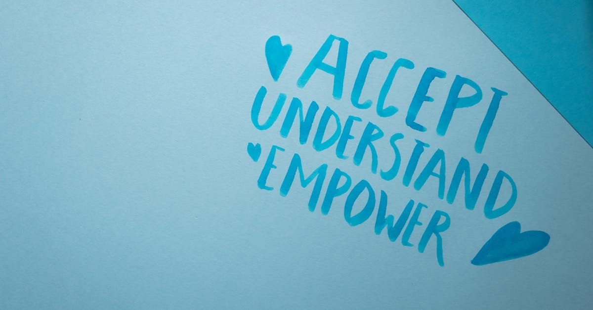 Blue background featuring handwritten words promoting acceptance, understanding, and empowerment.