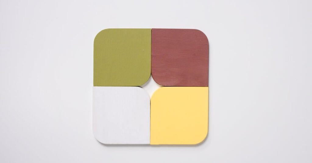A minimalist geometric pattern design featuring four colorful sections on a white background.