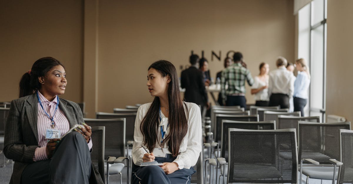 Two businesswomen in conversation during a break at a conference.
