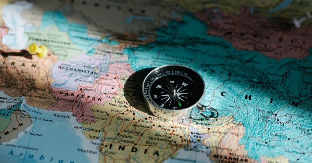 Close-up image of compass on a world map highlighting travel direction and exploration.