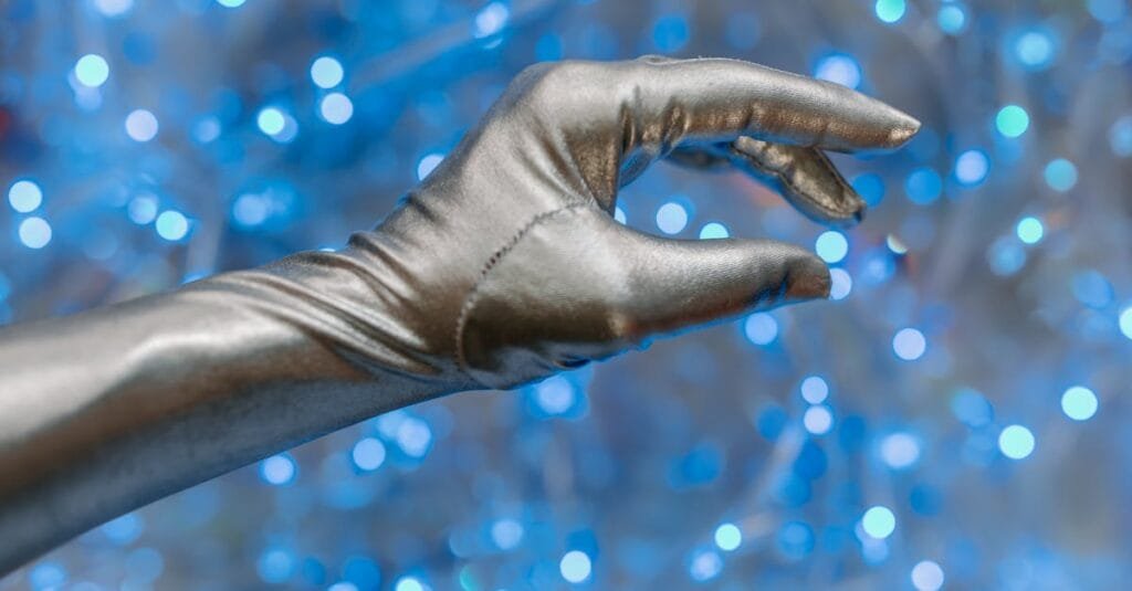 Close-up of a metallic glove against a vibrant blue bokeh background, evoking a futuristic theme.