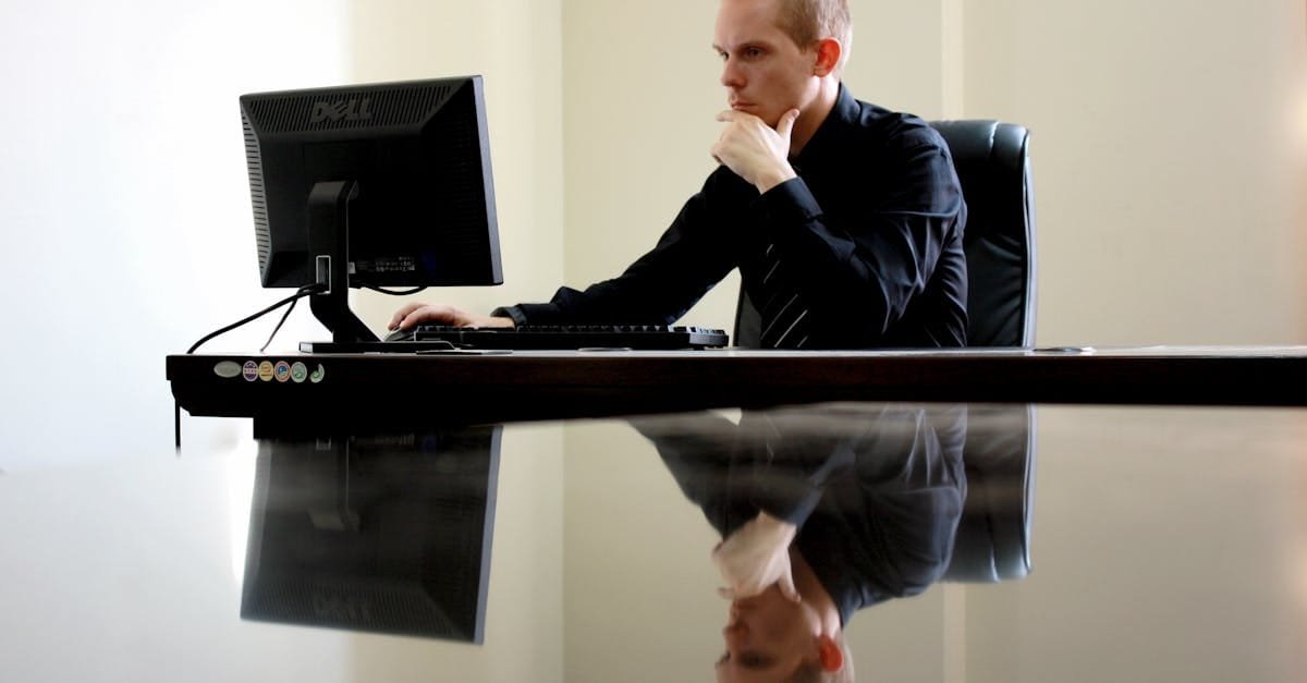 A businessman in deep thought at his desk, reflecting on work tasks.