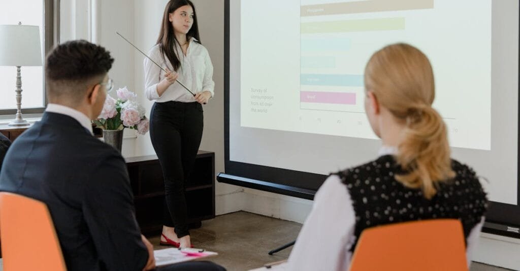 A young professional presenting data in a modern office to attentive colleagues.