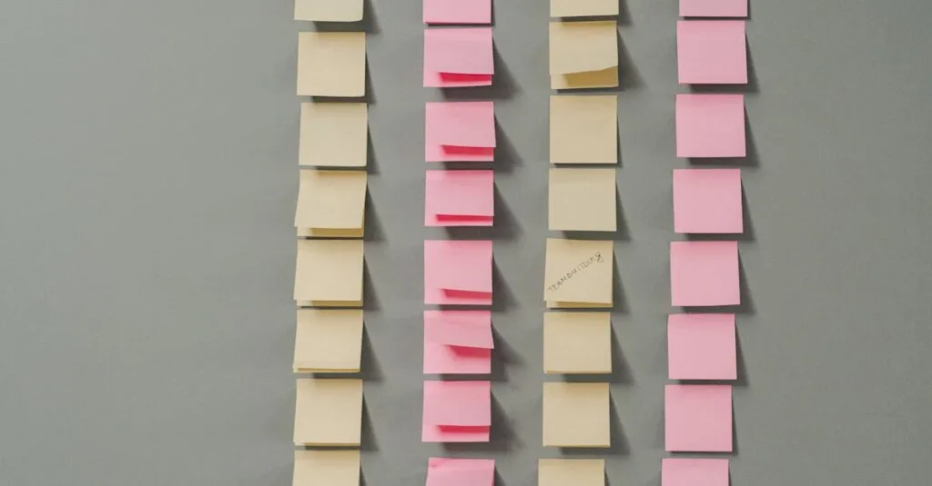 Rows of pink and yellow sticky notes on a gray background, ideal for planning concepts.