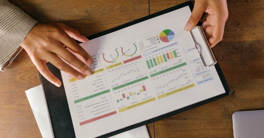 Top view of hands holding a financial report with colorful graphs and charts, ideal for business presentations.
