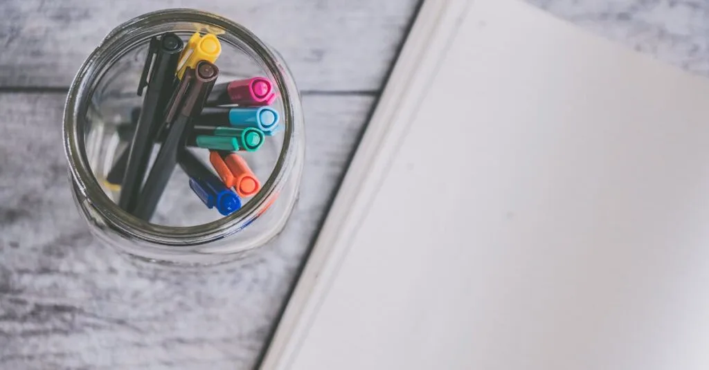 Top view of a glass jar filled with colorful pens next to an open notebook on a wooden desk.