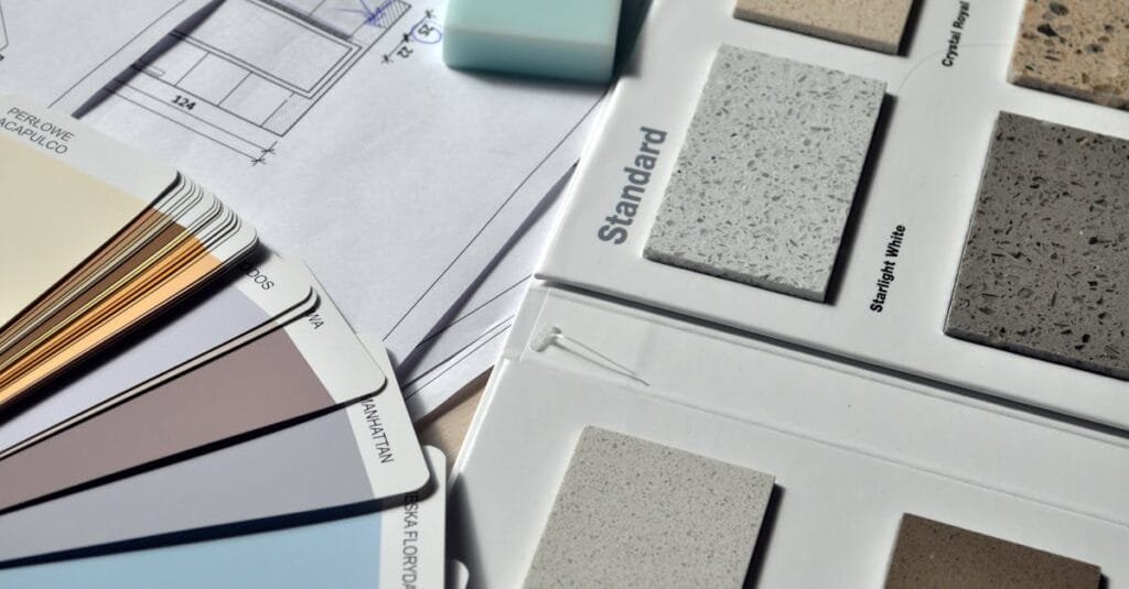 Color palette and material samples for interior renovation projects on a blueprint.